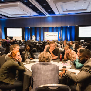 tables with participants at conference event