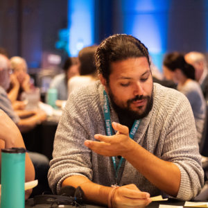 tables with participants at conference event