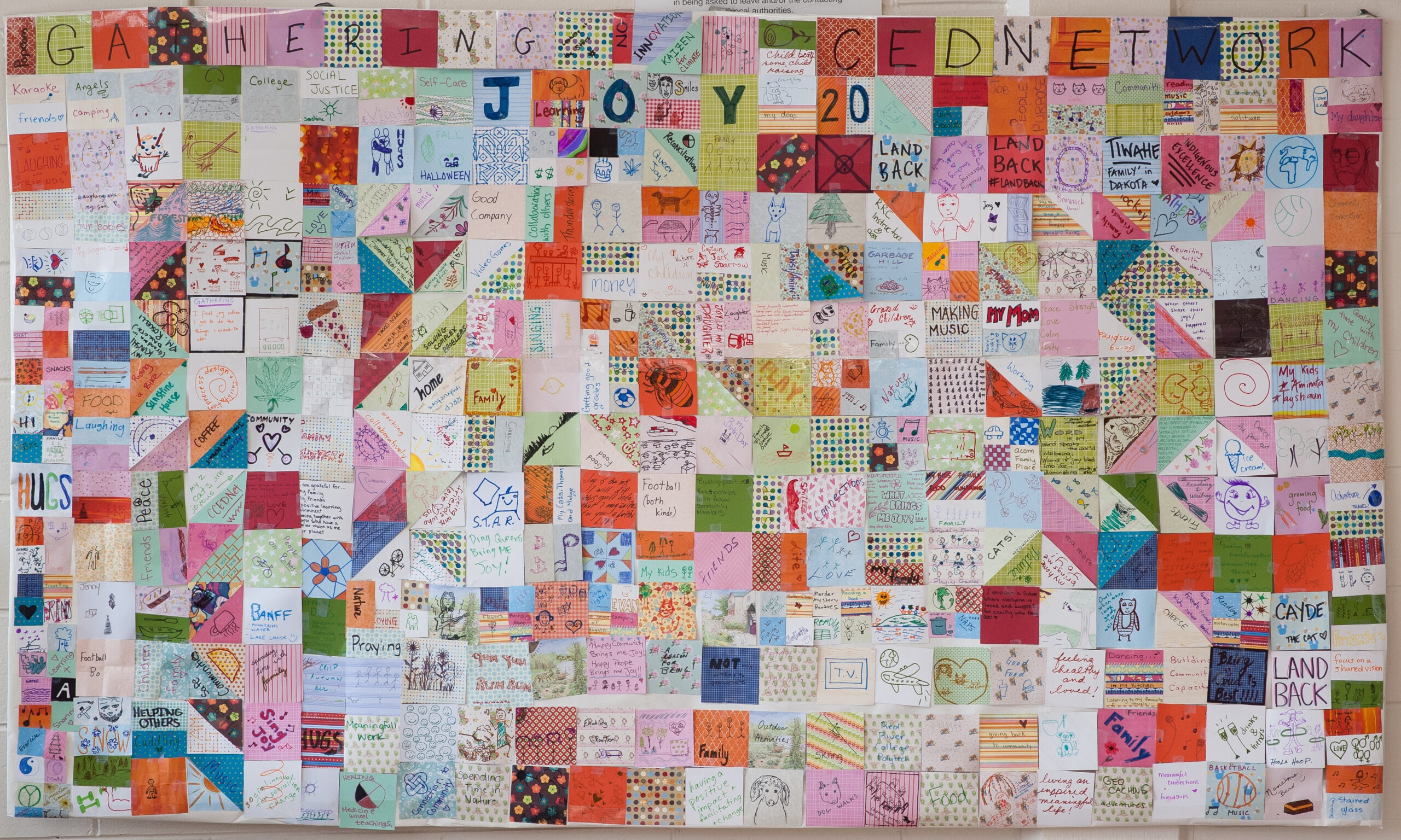 A patchwork quilt made from pieces of paper on which Manitoba Gathering attendees answered the question, "what brings you joy?"